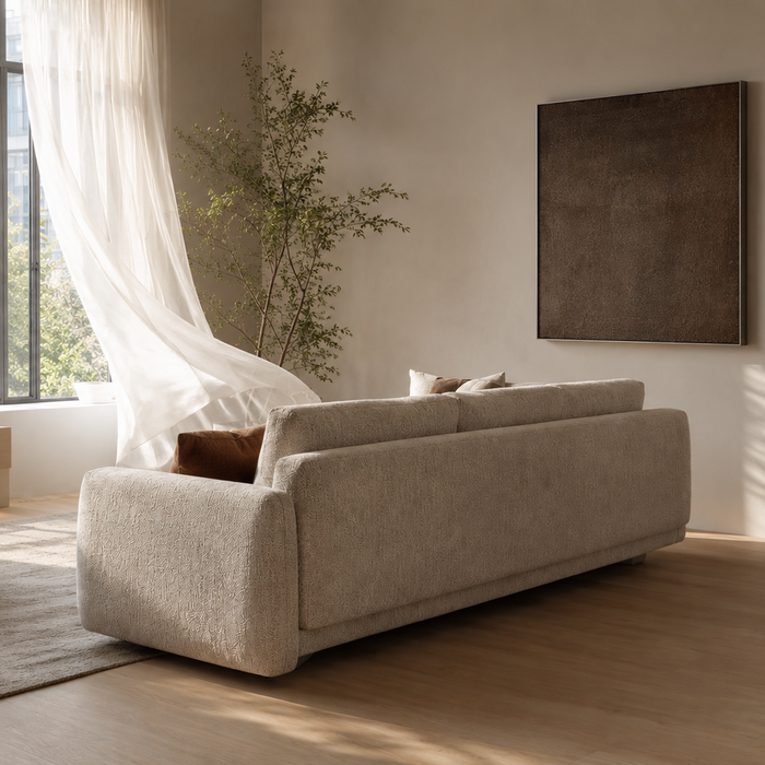 Why new couch smell lingers in some homes: elegant modern sofa with breathable airflow spacing, soft daylight, and indoor air quality-focused living room layout