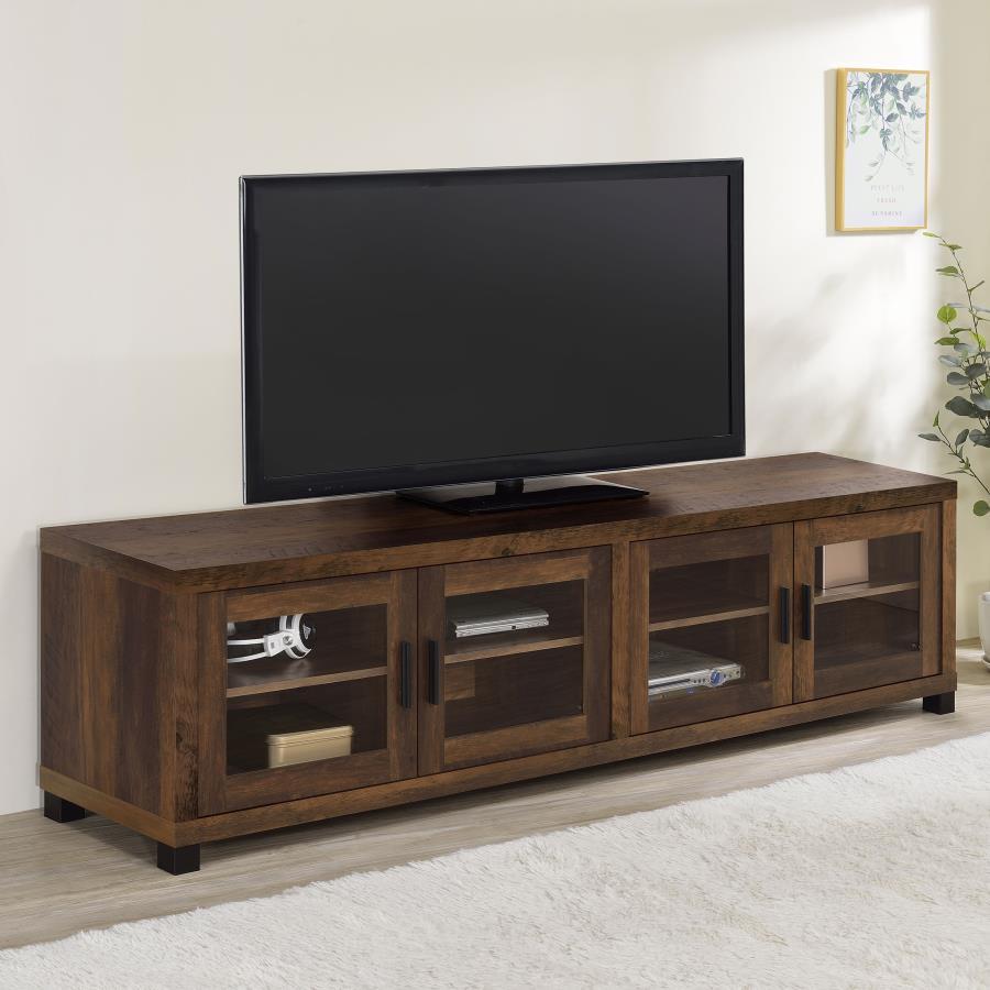 Dark wood Sachin 4-door TV stand in a living room setup with a TV placed on top of the stand.