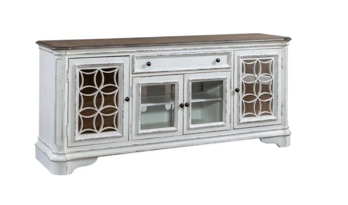 Angled view of traditional TV stand with glass doors and decorative overlays in weathered bisque finish